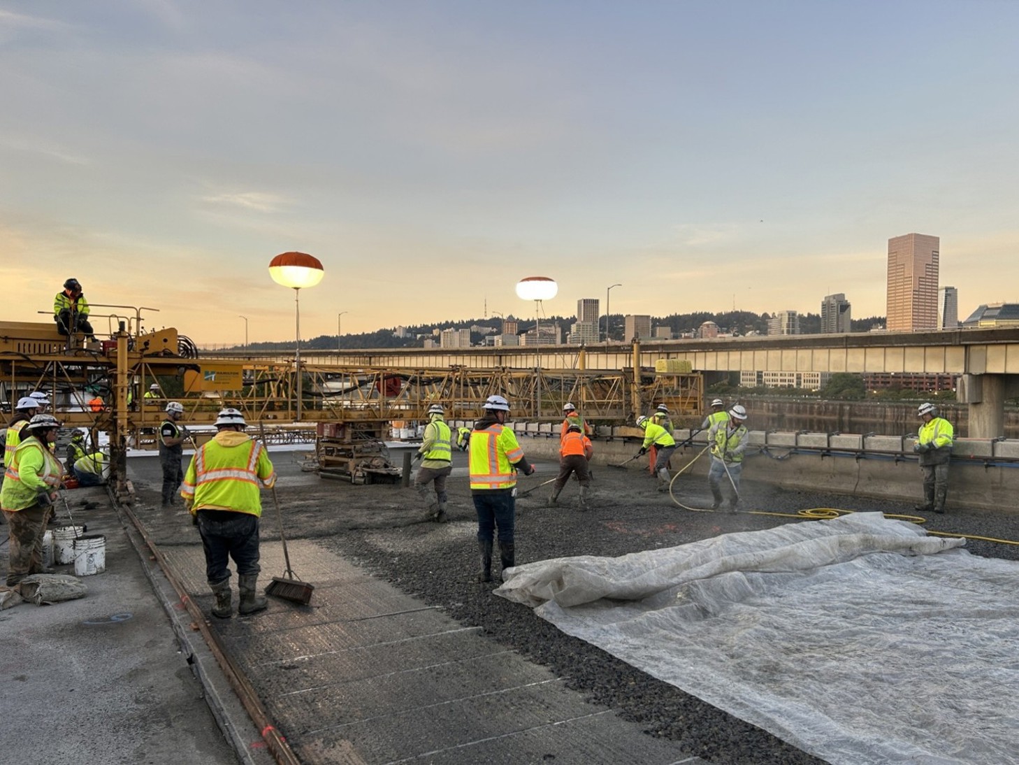 Construction crews pour a section of concrete on I-5 southbound.