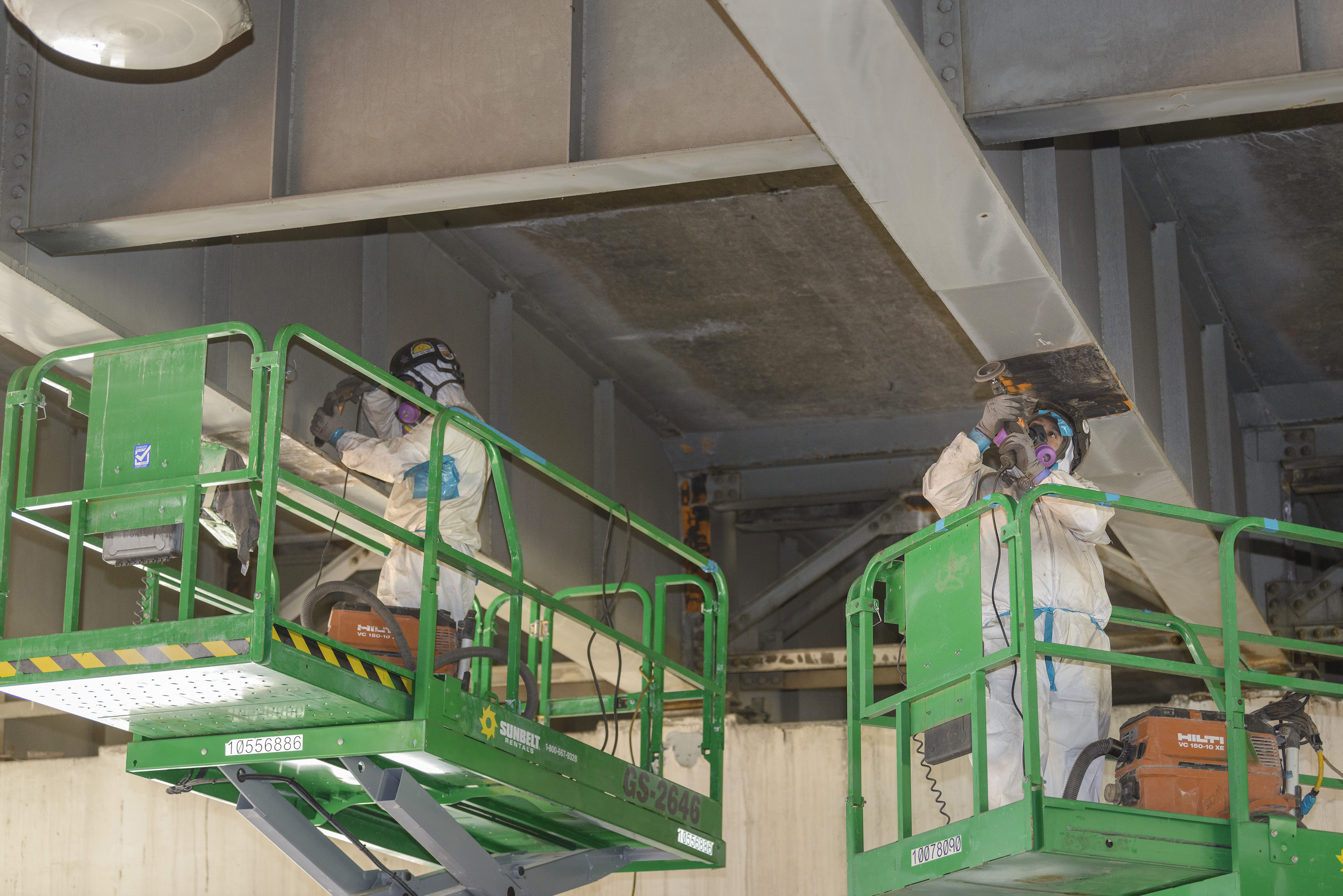 Crews work on removing lead paint on I-5 bridge supporting structures.